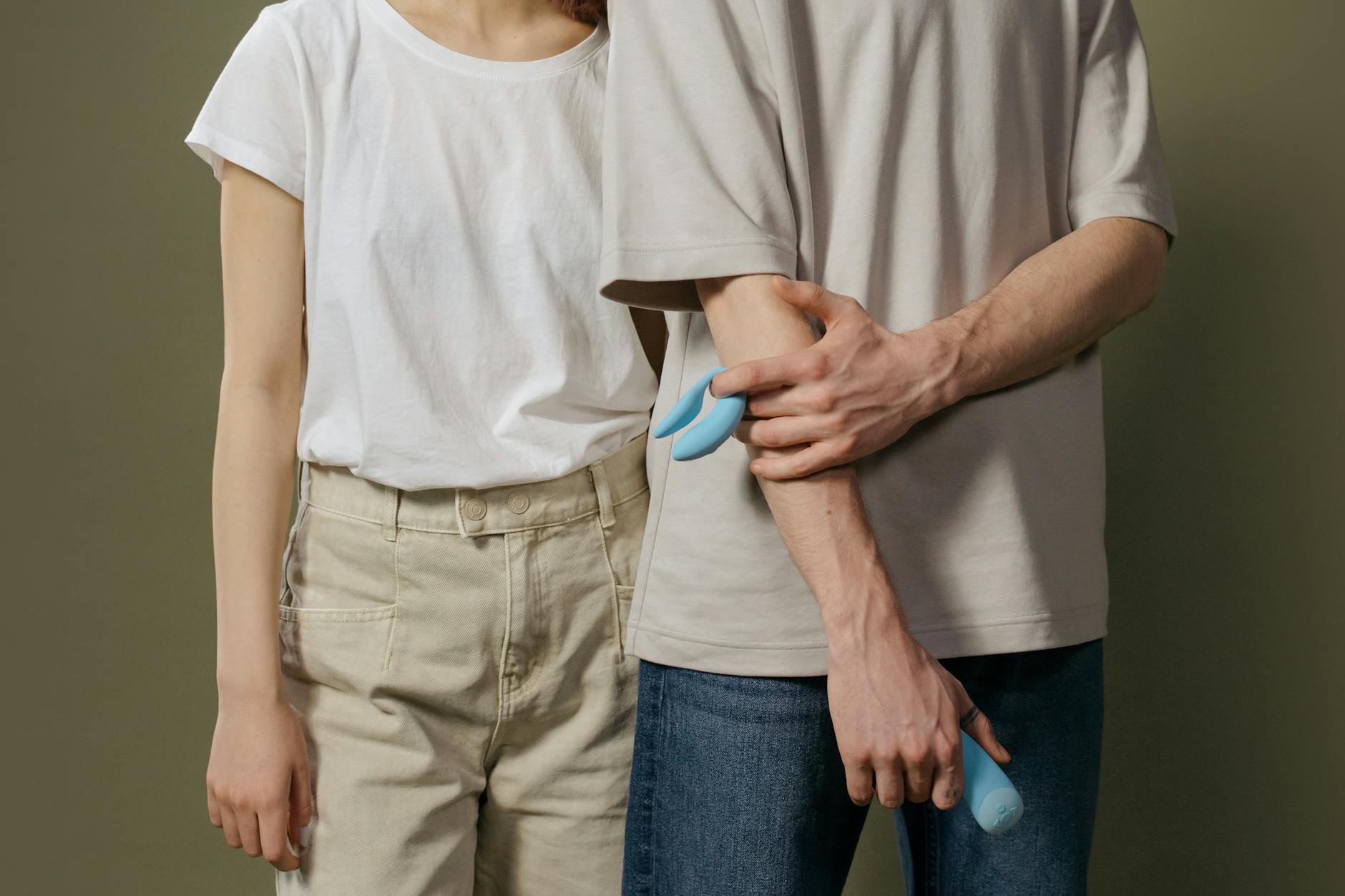 A couple holding a vibrator together, symbolizing shared intimacy and reconnection after betrayal.