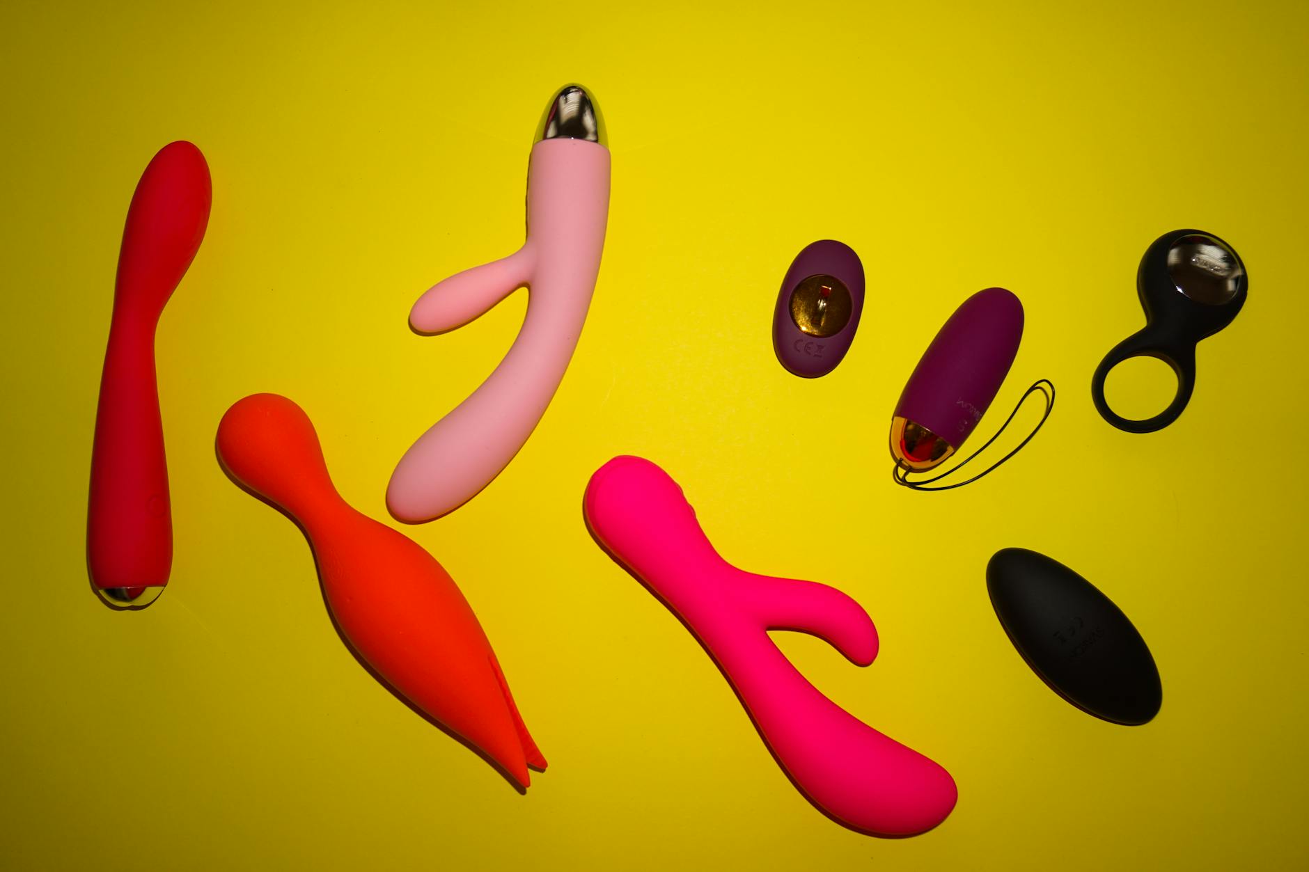 Array of colorful vibrators displayed close together on a bright background